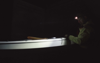 Kayaker with headlamp Kayaker sailing on a dark morning with his Suprabeam S3 headlamp