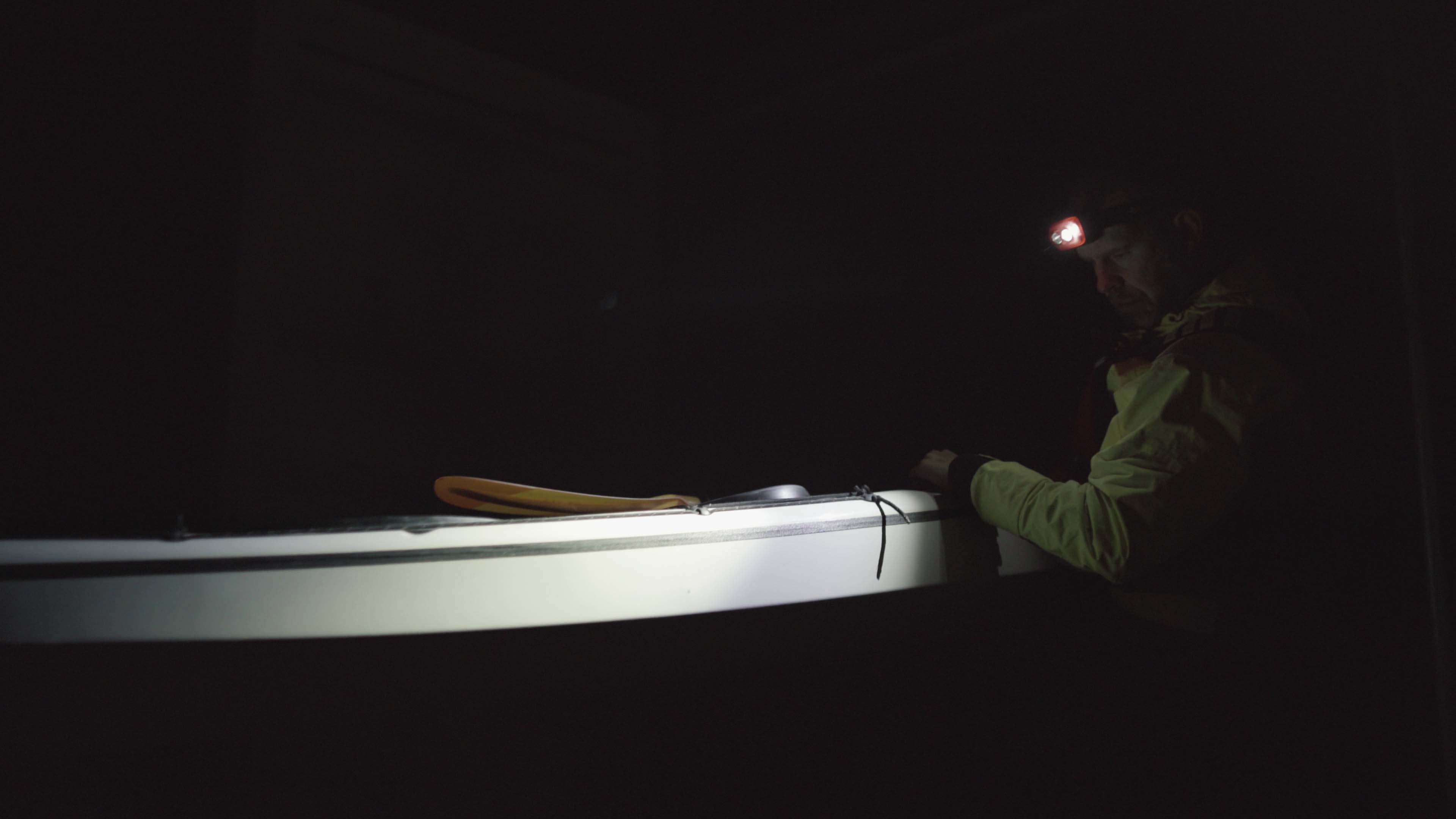 Kayaker with headlamp Kayaker sailing on a dark morning with his Suprabeam S3 headlamp