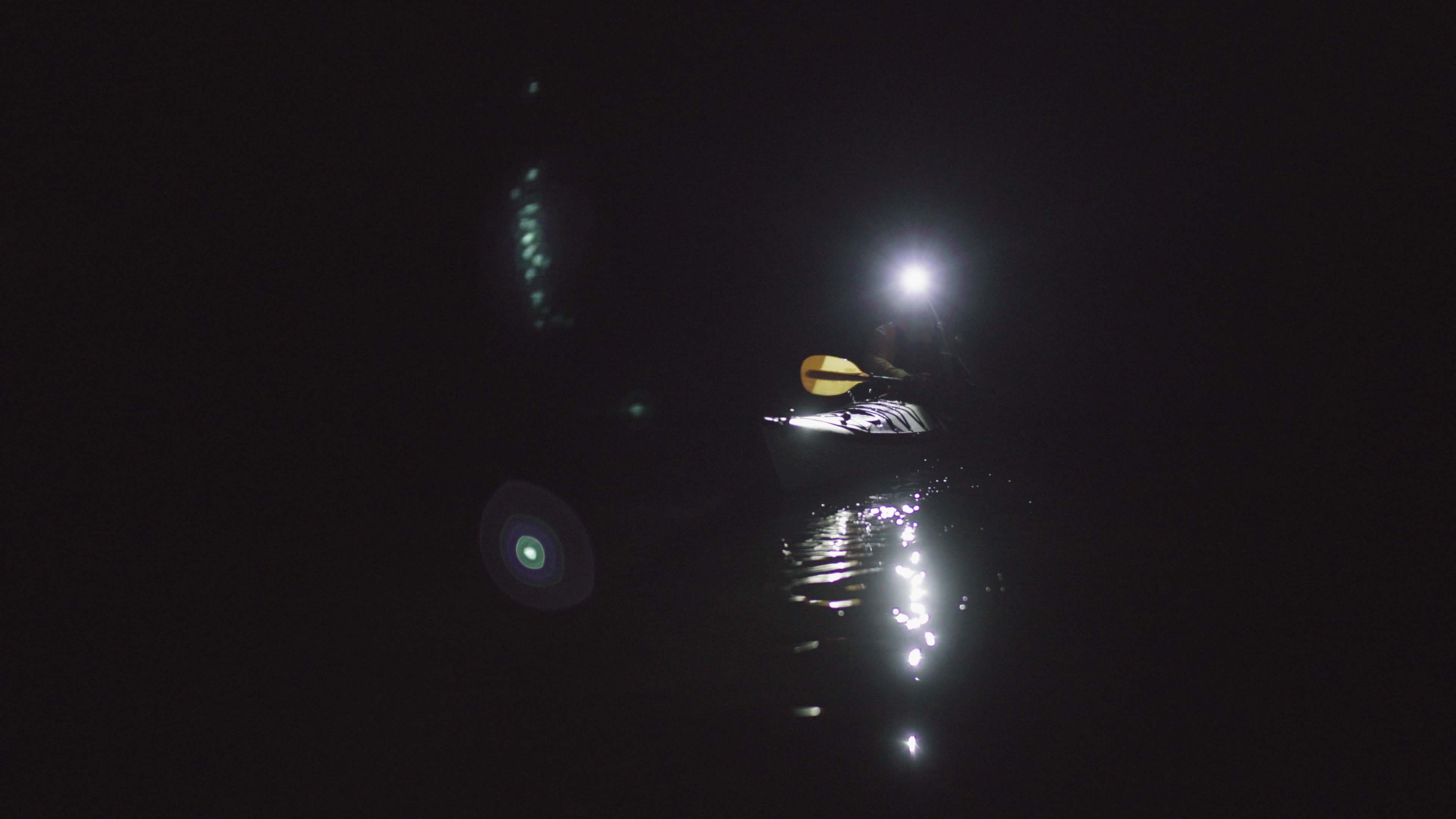 Kayaker with headlamp Kayaker sailing on a dark morning with his Suprabeam S3 headlamp