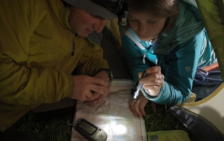 Hikers map reading 1 Hikers reading their map using flashlights