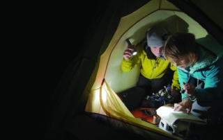 Hikers map reading Hikers reading their map using flashlights