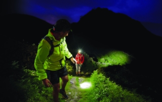 Hikers with headlamps Hikers using their headlamps to navigate in the dark