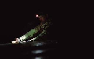 Kayaker with headlamp Kayaker sailing on a dark morning with his Suprabeam S3 headlamp