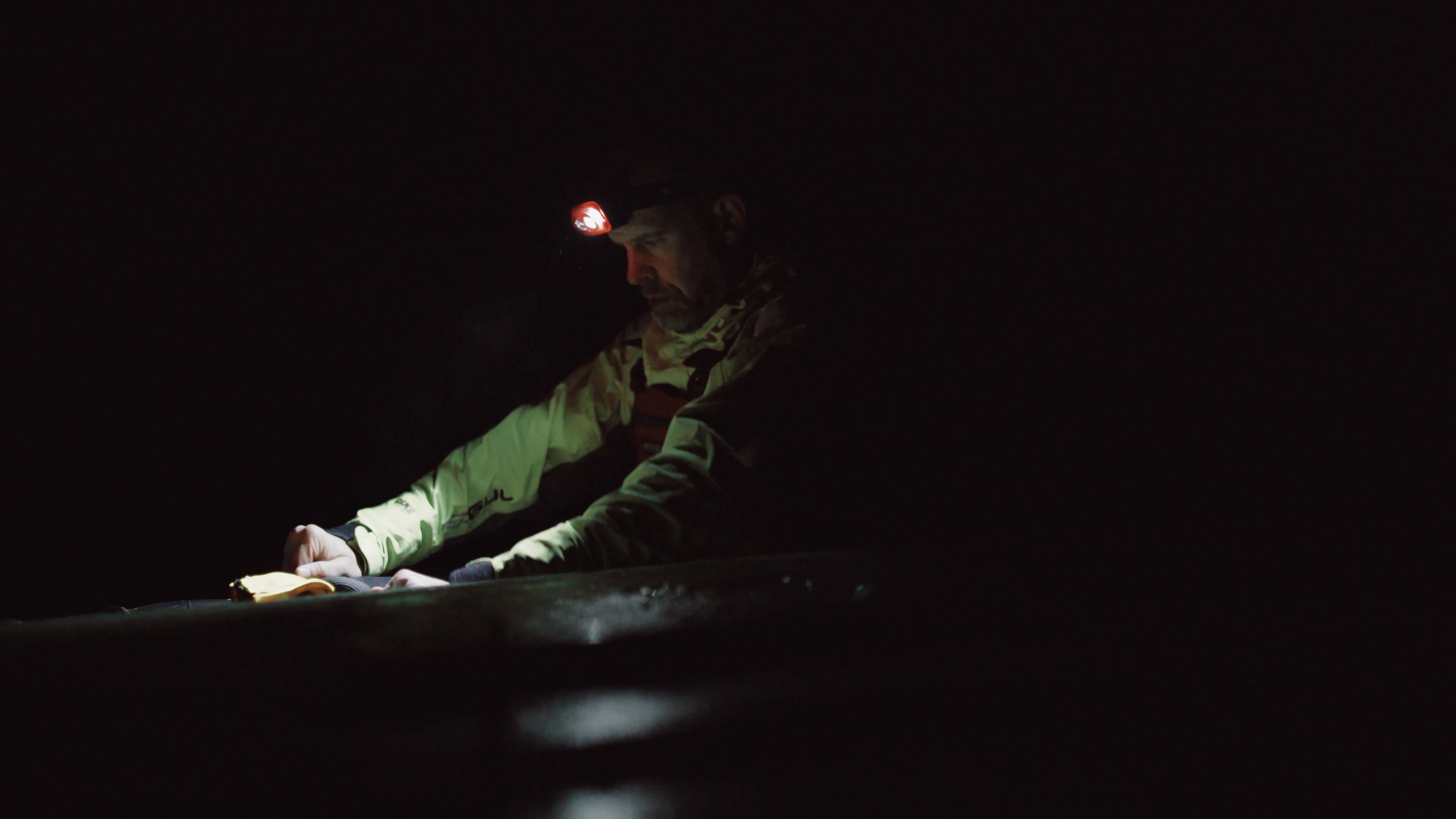 Kayaker with headlamp Kayaker sailing on a dark morning with his Suprabeam S3 headlamp
