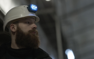 Electrician with helmet mounted headlamp Electrician working on a construction site, with a S4 rechargeable headlamp mounted on his safety helmet