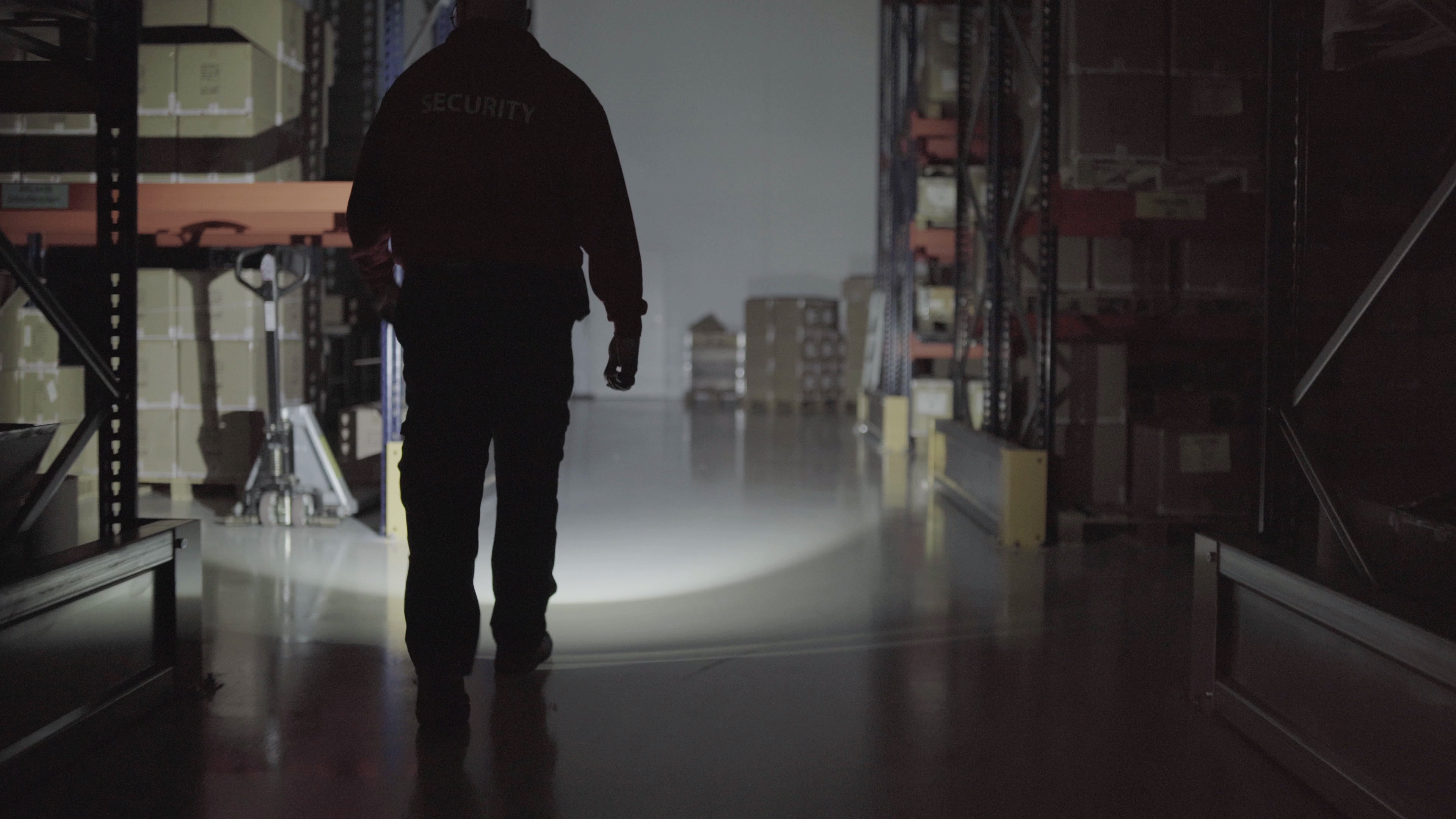 Security_2 Security guard inspecting warehouse at night