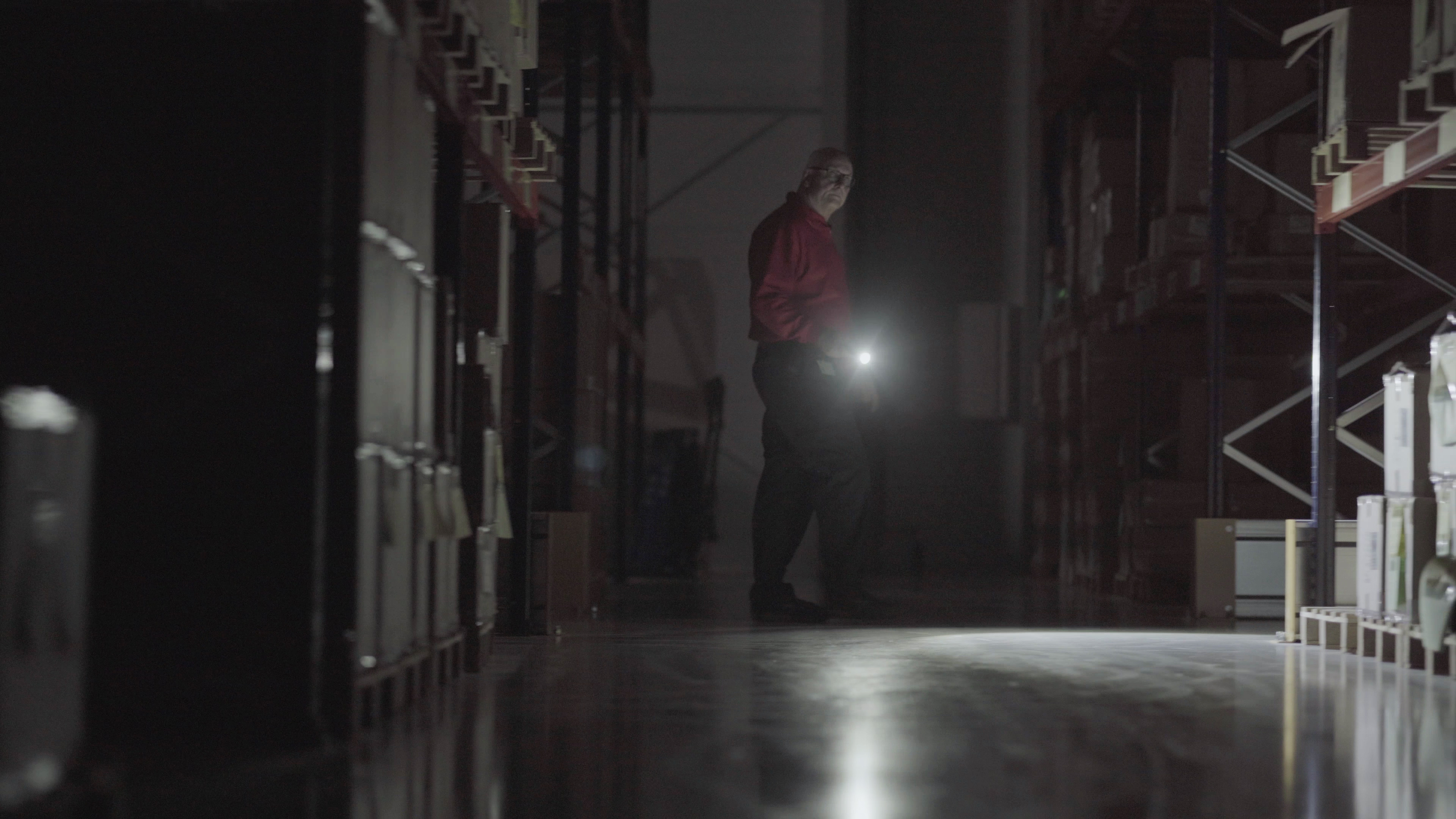 Security_3 Security guard inspecting warehouse at night