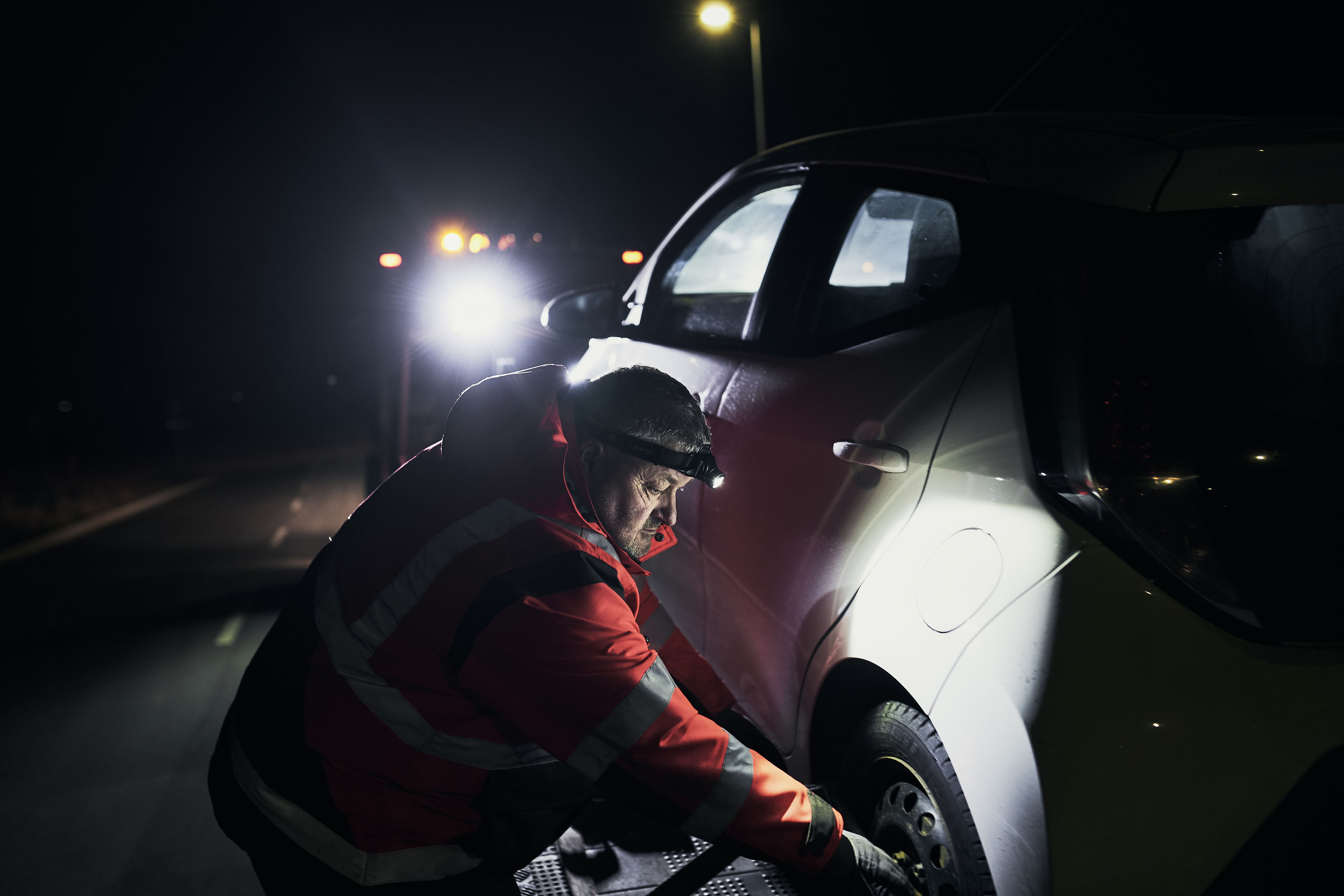 roadside_assistance_9 Roadside assistance officer working with headlamp